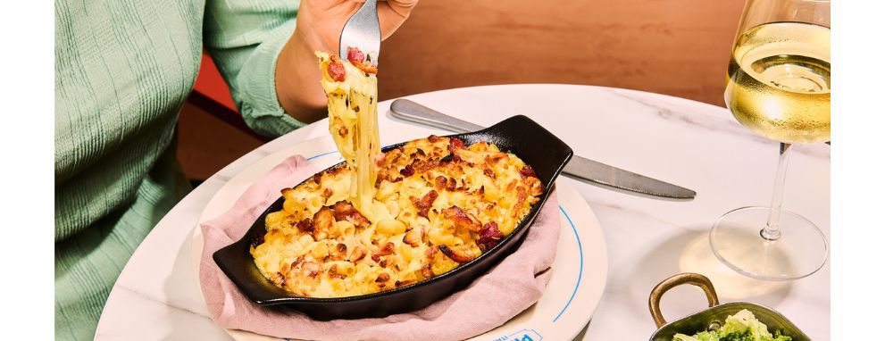 Someone eating pasta and a salad at Prezzo