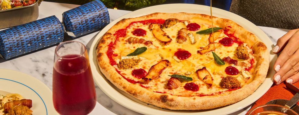 Someone eating pasta and a salad at Prezzo